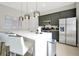 Modern kitchen with dark gray cabinets, stainless steel appliances, and white countertops at 7770 Sandy Ridge Dr # 114, Reunion, FL 34747