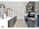 Kitchen with dark gray cabinets, stainless steel appliances, white countertops, and island at 7770 Sandy Ridge Dr # 114, Reunion, FL 34747