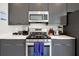 Close-up of kitchen counter with stainless steel appliances and white countertop at 7770 Sandy Ridge Dr # 114, Reunion, FL 34747
