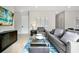 Living room with gray couches, a glass coffee table, and artwork on the wall at 7770 Sandy Ridge Dr # 114, Reunion, FL 34747