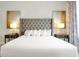 Close-up of the king-size bed with tufted headboard in the main bedroom at 7770 Sandy Ridge Dr # 114, Reunion, FL 34747