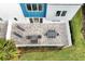 Paved patio area with a dining table set, lounge chairs and green landscaping at 7770 Sandy Ridge Dr # 114, Reunion, FL 34747
