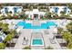 Resort-style pool with a hot tub, lounge chairs, and lush landscaping at 7770 Sandy Ridge Dr # 114, Reunion, FL 34747