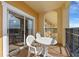 Relaxing balcony with table and chairs and sliding door access at 8112 Poinciana Blvd # 1709, Orlando, FL 32821