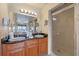 Double vanity bathroom with granite countertop and walk-in shower at 8112 Poinciana Blvd # 1709, Orlando, FL 32821