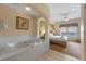 Bathroom with jacuzzi tub and view into main bedroom at 8112 Poinciana Blvd # 1709, Orlando, FL 32821