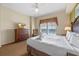 Spacious bedroom with king-size bed, dresser, and a view at 8112 Poinciana Blvd # 1709, Orlando, FL 32821