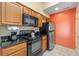 Modern kitchen with black appliances and granite countertops at 8112 Poinciana Blvd # 1709, Orlando, FL 32821