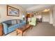 Comfortable living room featuring a blue sofa and green armchair at 8112 Poinciana Blvd # 1709, Orlando, FL 32821