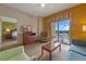 Spacious living room with ample seating and views of the outdoors from a sliding glass door at 8112 Poinciana Blvd # 1709, Orlando, FL 32821