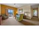 Comfortable living room featuring a sofa and armchair, with access to a balcony at 8112 Poinciana Blvd # 1709, Orlando, FL 32821