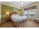 King-size bed, wood furniture, and large windows with a view at 8112 Poinciana Blvd # 1709, Orlando, FL 32821