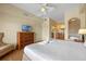 King bed, TV, and ensuite bathroom with a jacuzzi tub at 8112 Poinciana Blvd # 1709, Orlando, FL 32821