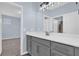 Modern bathroom with gray vanity, quartz countertop and mirror at 902 Lady Bird Ln, Orange City, FL 32763