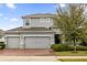 Two-story house with gray siding, brick driveway, and landscaping at 902 Lady Bird Ln, Orange City, FL 32763