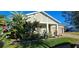 House with lush tropical landscaping, a covered porch, and a two-car garage at 3811 Island Green Way, Orlando, FL 32824