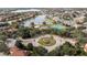 Aerial view of community with lake, pool, and tennis courts at 11410 Rapallo Ln, Windermere, FL 34786