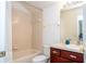 Clean bathroom with tub shower combo, wood vanity, and updated fixtures at 11410 Rapallo Ln, Windermere, FL 34786