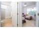 Clean bathroom with tub shower combo and adjacent bedroom at 11410 Rapallo Ln, Windermere, FL 34786