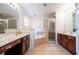 Elegant bathroom with double sinks, soaking tub, and shower at 11410 Rapallo Ln, Windermere, FL 34786