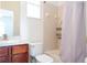 Clean bathroom with a tub shower combo and wood vanity at 11410 Rapallo Ln, Windermere, FL 34786