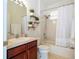 Updated bathroom with a tub shower combo and wood vanity at 11410 Rapallo Ln, Windermere, FL 34786
