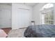 Bright bedroom featuring a queen bed, large window, and ample closet space at 11410 Rapallo Ln, Windermere, FL 34786