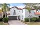 Two-story house with white walls, brown garage door, and a red tile roof at 11410 Rapallo Ln, Windermere, FL 34786