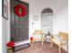 Front porch with two chairs, a Christmas wreath and festive decorations at 11410 Rapallo Ln, Windermere, FL 34786