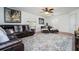 Spacious living room with sectional sofa, large TV, and ceiling fan at 11410 Rapallo Ln, Windermere, FL 34786