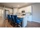 Modern kitchen with white cabinets, quartz countertops, and blue barstools at 1172 Pearl Tree Rd, Deltona, FL 32725