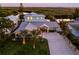 Modern coastal home with metal roof and landscaped yard near the water at 25 Cunningham Dr, New Smyrna Beach, FL 32168