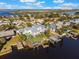Daytime aerial view of waterfront home with dock, pool, and surrounding neighborhood at 25 Cunningham Dr, New Smyrna Beach, FL 32168