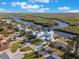 Aerial view of a waterfront home with a metal roof, pool, and dock at 25 Cunningham Dr, New Smyrna Beach, FL 32168