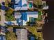 An aerial view of a Florida home with a pool, boat dock, and lush backyard at 25 Cunningham Dr, New Smyrna Beach, FL 32168