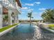 Inviting backyard oasis with a sparkling pool, spa, and lush landscaping at 25 Cunningham Dr, New Smyrna Beach, FL 32168