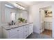 Bathroom with white double vanity, granite countertop, and a large mirror at 25 Cunningham Dr, New Smyrna Beach, FL 32168