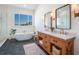 Modern bathroom with a double vanity, freestanding tub, and walk-in shower at 25 Cunningham Dr, New Smyrna Beach, FL 32168