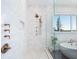 Modern shower with gold fixtures, white tile, and a window view at 25 Cunningham Dr, New Smyrna Beach, FL 32168