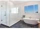 Spacious bathroom with a glass shower, freestanding tub, and tiled floor at 25 Cunningham Dr, New Smyrna Beach, FL 32168