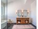 Double vanity with wooden cabinet, mirrors, and sconce lighting at 25 Cunningham Dr, New Smyrna Beach, FL 32168