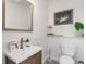 Powder room featuring white walls, wooden vanity, and decorative mirror at 25 Cunningham Dr, New Smyrna Beach, FL 32168