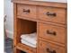 Wooden bathroom vanity with drawers, open shelving, and black hardware at 25 Cunningham Dr, New Smyrna Beach, FL 32168