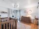 Baby's Bedroom with crib, dresser, and soft, neutral colors at 25 Cunningham Dr, New Smyrna Beach, FL 32168