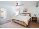 Cozy bedroom with a wooden bed frame, ceiling fan, and rug at 25 Cunningham Dr, New Smyrna Beach, FL 32168