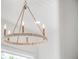 Close-up of a stylish chandelier with a circular rope design and warm lighting at 25 Cunningham Dr, New Smyrna Beach, FL 32168
