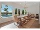 Bright dining room with a large table, wicker chairs, and pool views at 25 Cunningham Dr, New Smyrna Beach, FL 32168