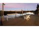 Private dock with seating overlooking tranquil waters at sunset at 25 Cunningham Dr, New Smyrna Beach, FL 32168