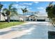 Charming two-story coastal home with a white exterior, metal roof, and landscaped yard at 25 Cunningham Dr, New Smyrna Beach, FL 32168