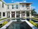 Luxury home with pool, spa, outdoor kitchen, and a second-story balcony at 25 Cunningham Dr, New Smyrna Beach, FL 32168
